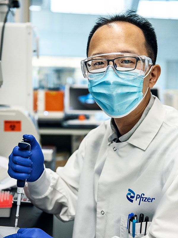 lab technician filling vial