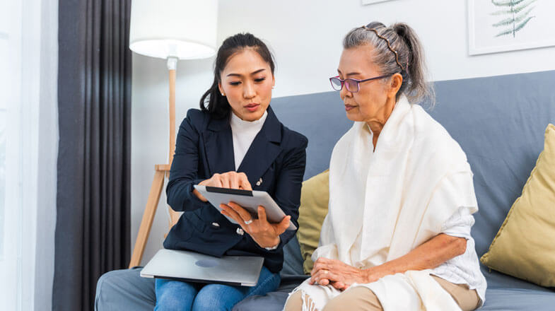 daughter reviewing health data details with mother on a tablet (thumbnail)