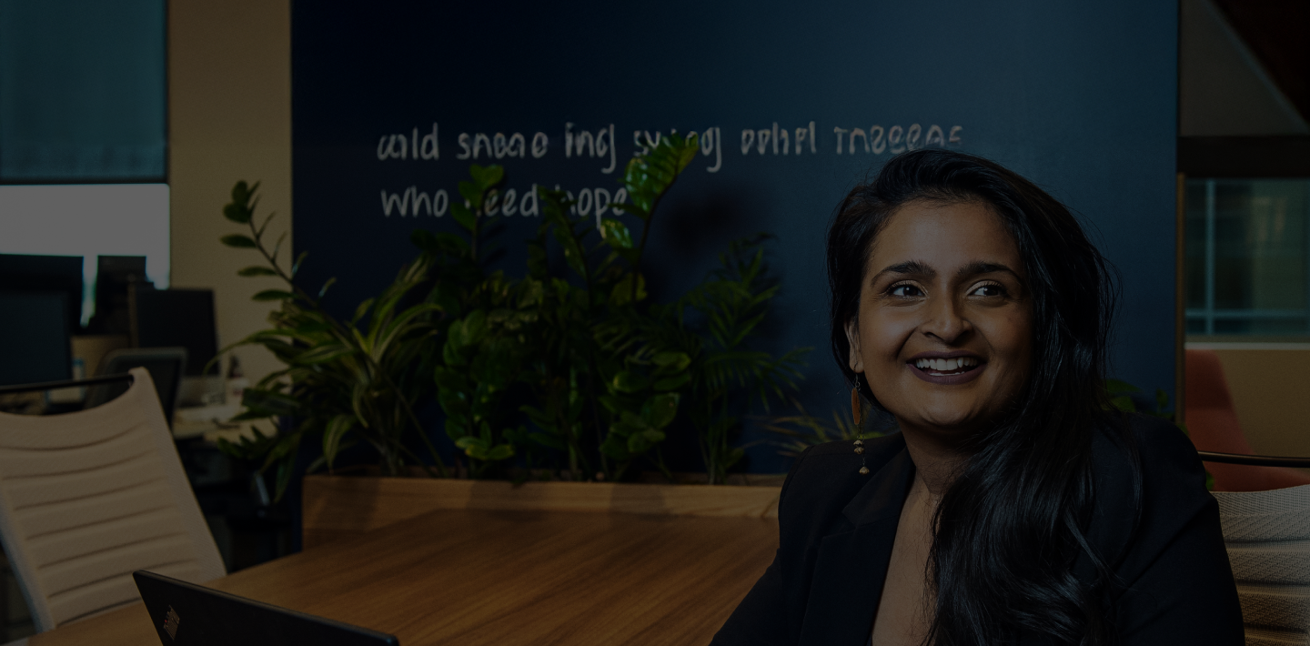   image of employee sitting in a open office space.
