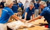 Pfizer colleagues volunteer their time by packing meals for those in need.