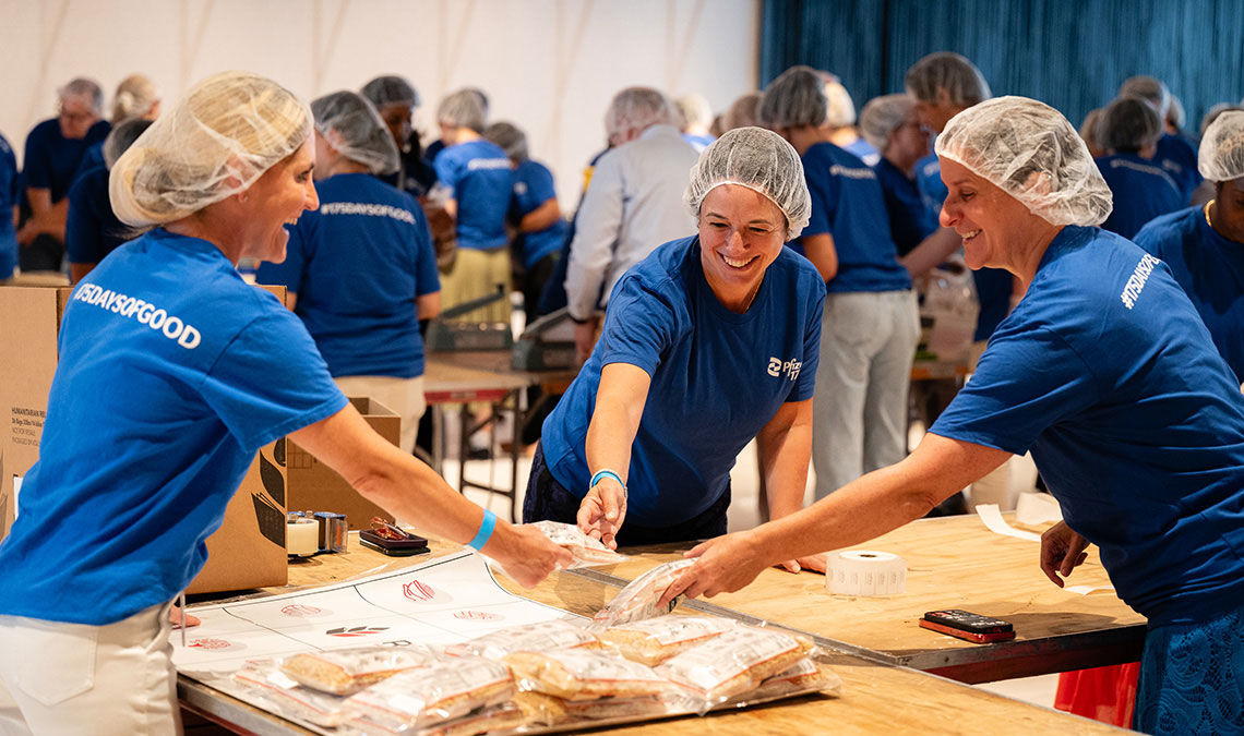 group photo new york pfizer offices volunteers preparing meals