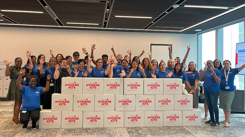 Pfizer colleagues celebrate packing hygiene kits