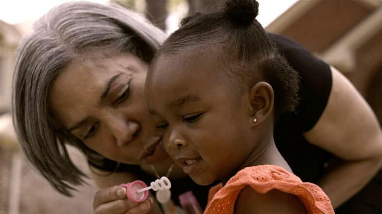  Lynce blowing bubbles with child thumbnail