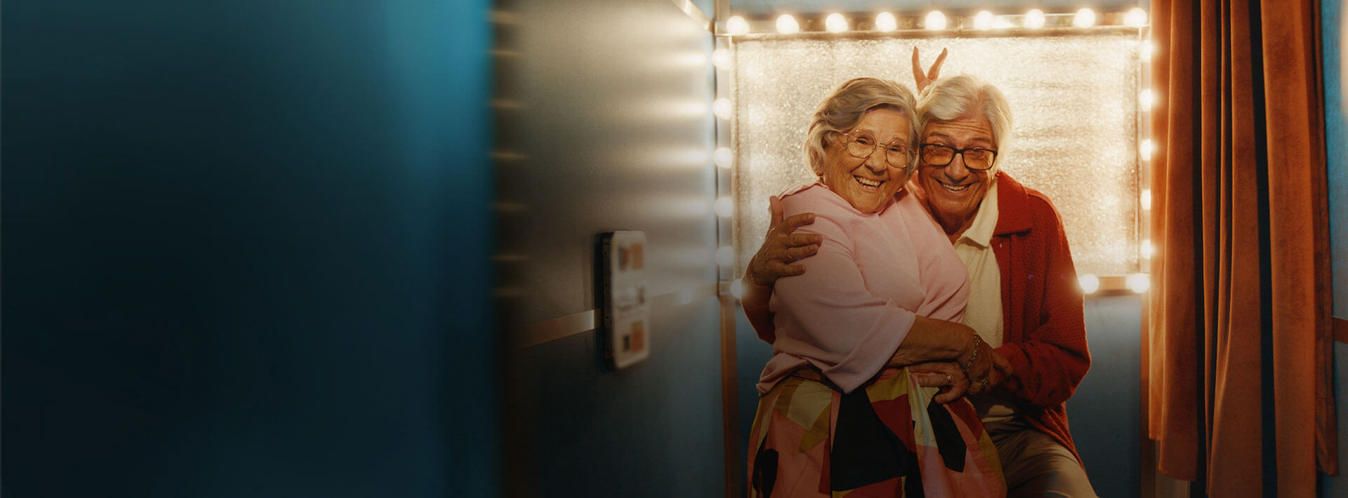   Elderly couple posing for picture in photobooth
