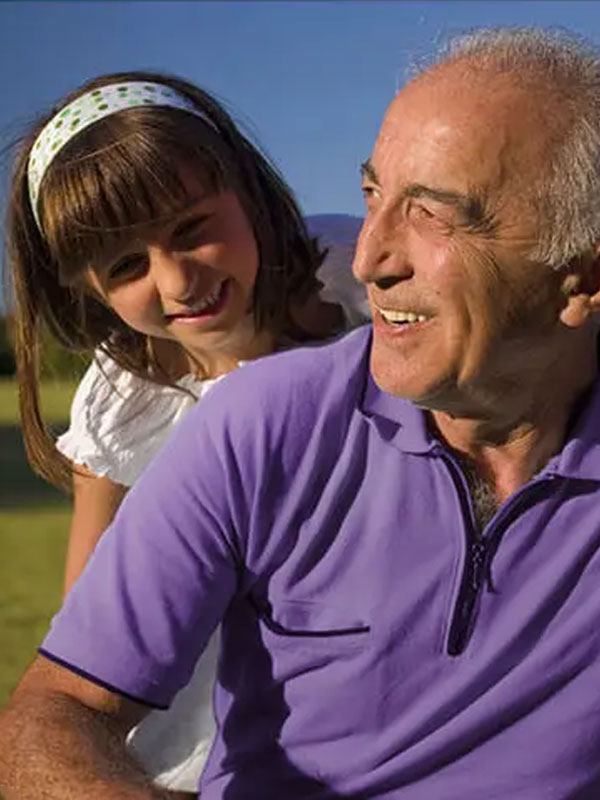 Grandfather smiling and posing with child