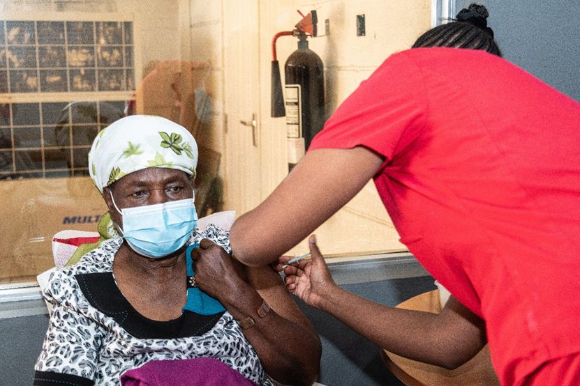 A community member while receiving a COVID-19 vaccine in Uganda