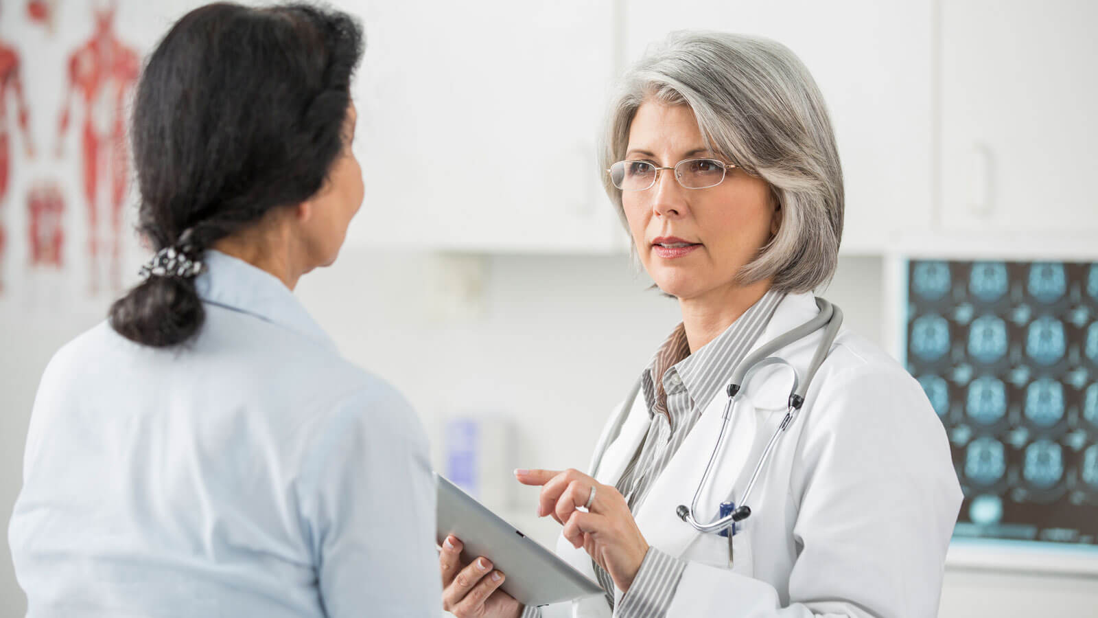 Doctor examining patient in office