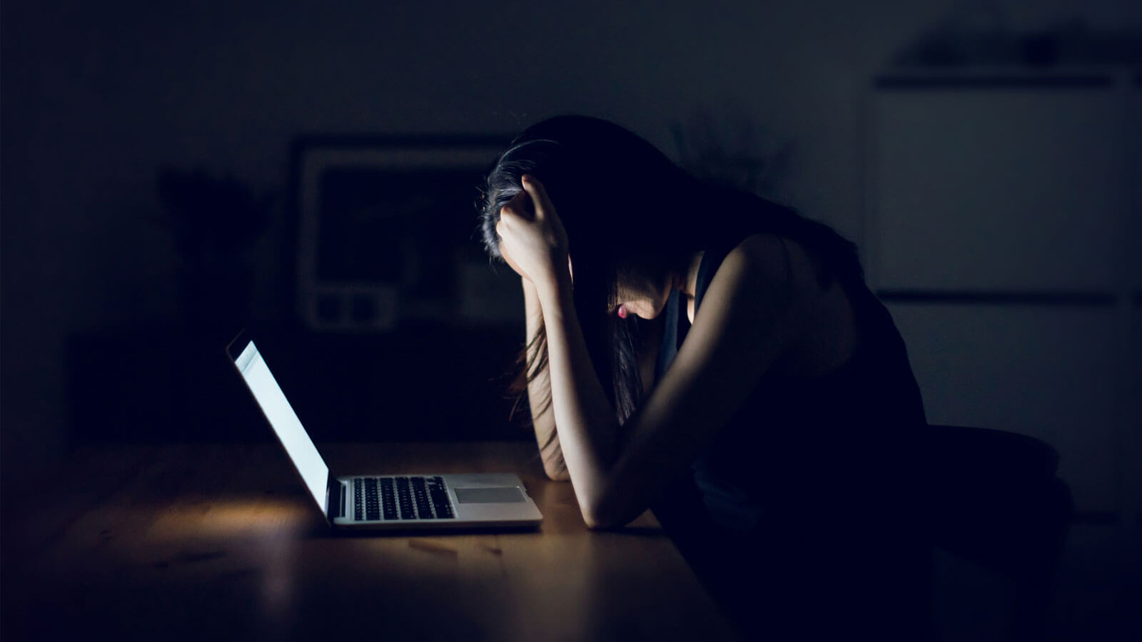 Stressed and frustrated businesswoman working till late at work