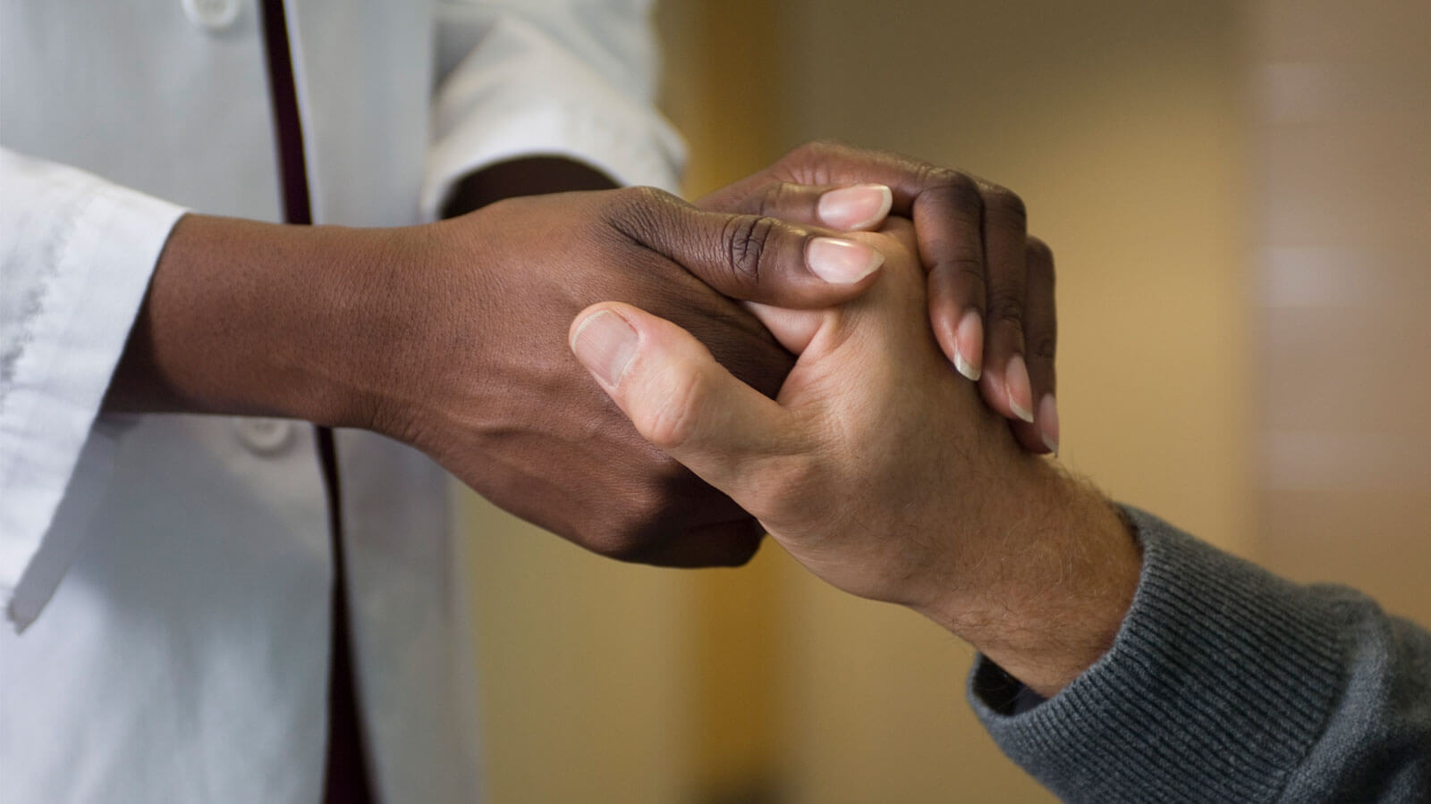 Doctor holding patient's hand