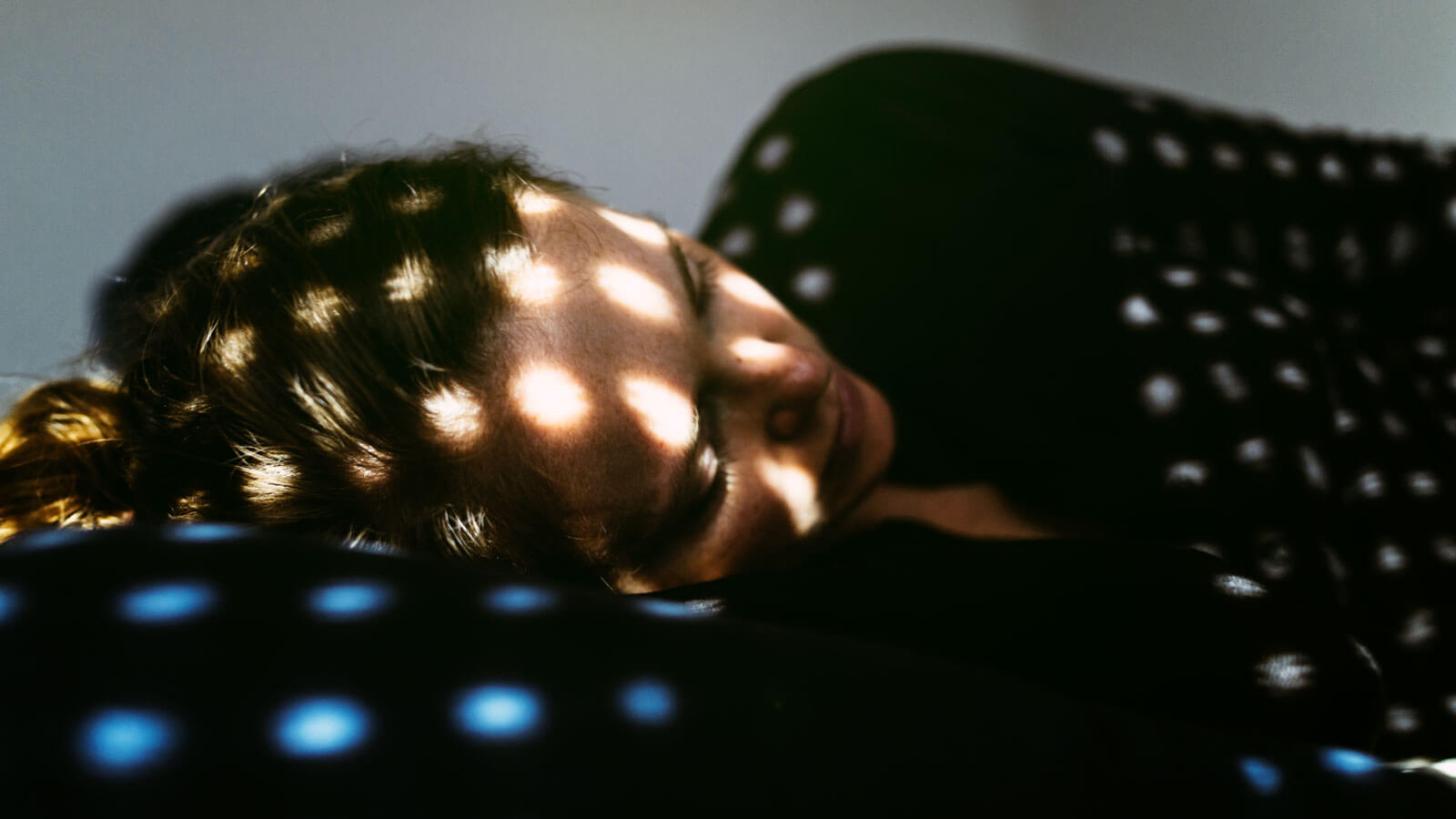 Depressed woman lying on the bed at home