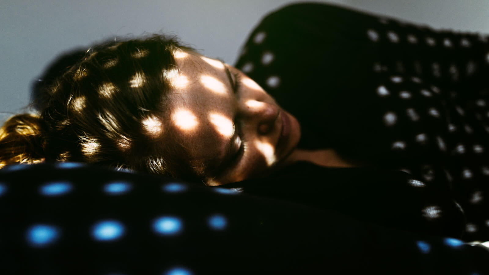 Depressed woman lying on the bed at home.