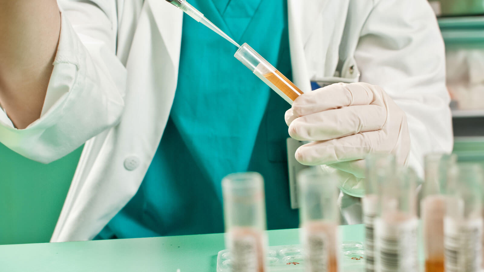 lab scientist filling vial
