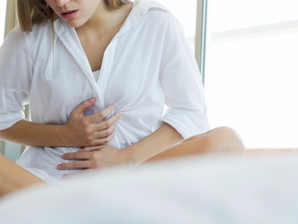Woman experiencing abdominal pain