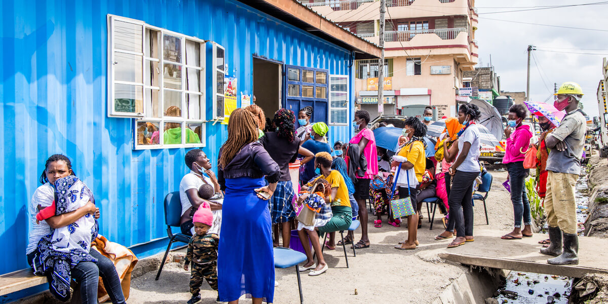 various people waiting in line for healthcare service