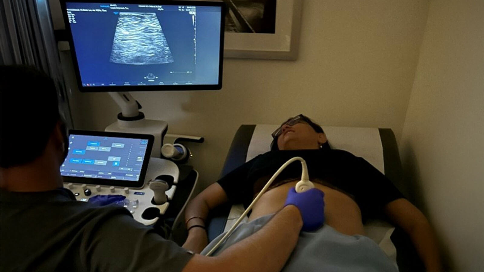Technician performing sonogram