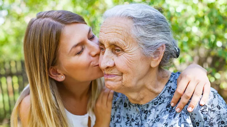 Daughter kissing grandmother thumbnail