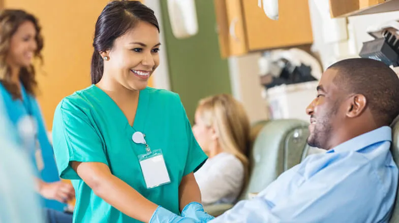 Nurse tending to patient thumbnail image