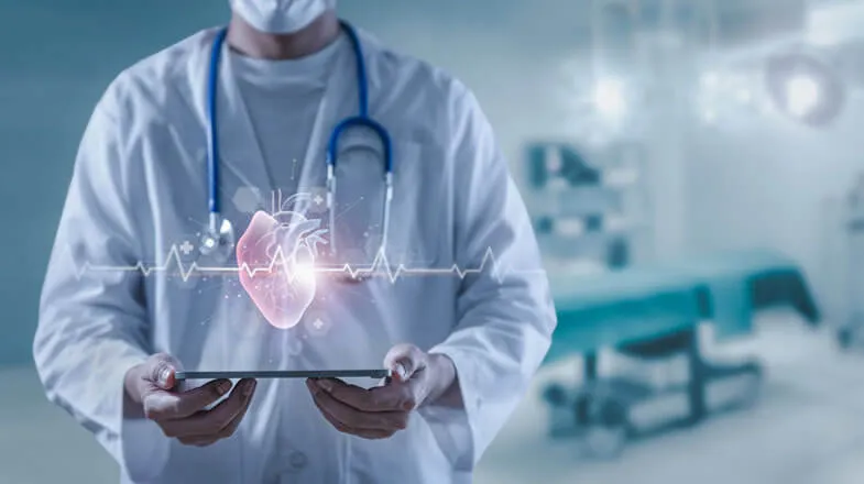 Doctor holding tablet with glowing heart and ECG graphic in a hospital room thumbnail