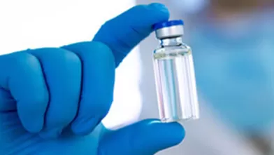 scientist holding vaccine vial
