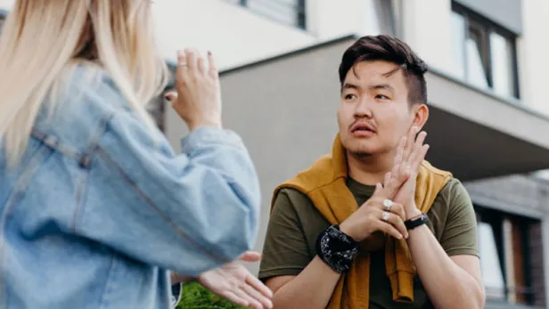 Man and women communicating through sign language