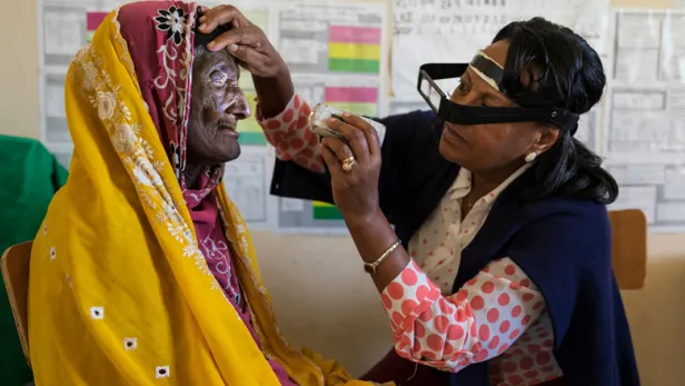 Doctor inspecting patient's eye