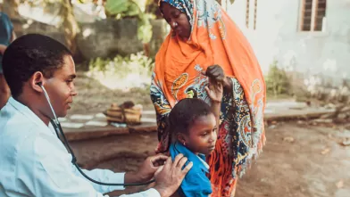 Doctor helping patients outside
