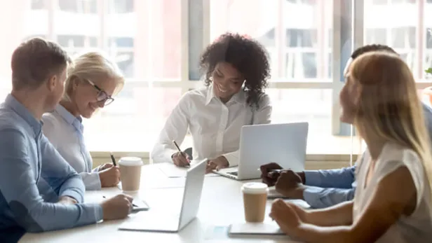 Colleagues around the table in a meeting thumbnail