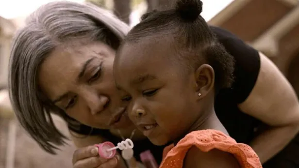  Lynce blowing bubbles with child thumbnail