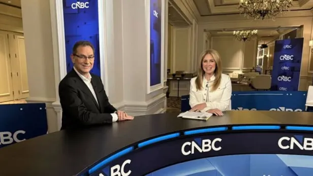 Photograph of two CNBC hosts seated at a news desk in an elegant studio thumbnail